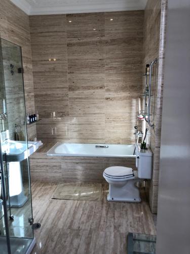 a bathroom with a tub and a toilet and a sink at Luxurious royal estate in historic Sintra paradise in Sintra