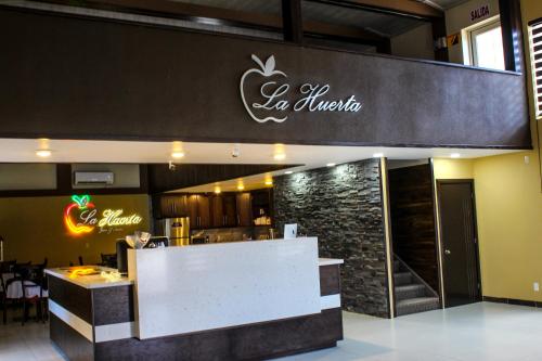 a restaurant with a sign for an event at La Huerta Inn & Suites in Cuauhtémoc