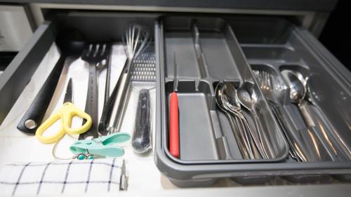 a drawer filled with utensils on a table at Comfortable Stays - Shirley, Solihull in Birmingham