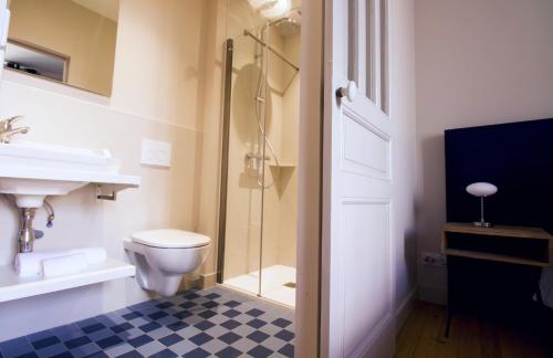 a bathroom with a toilet and a glass shower at LES CORDERIES in Les Sables-d'Olonne