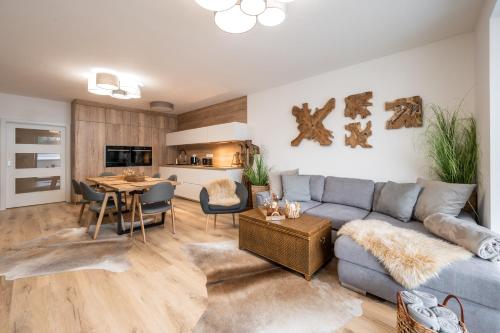 a living room with a couch and a table at Apartmány Kaskády Luhačovice in Luhačovice