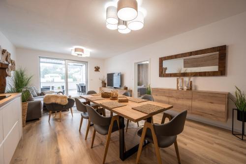 a dining room and living room with a table and chairs at Apartmány Kaskády Luhačovice in Luhačovice