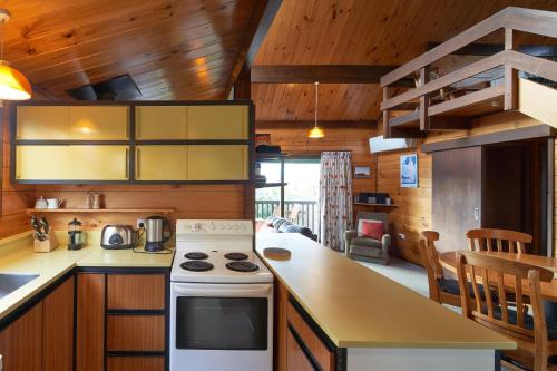 a kitchen with wooden cabinets and a stove top oven at Retro Inn 1 - Lake Tekapo in Lake Tekapo