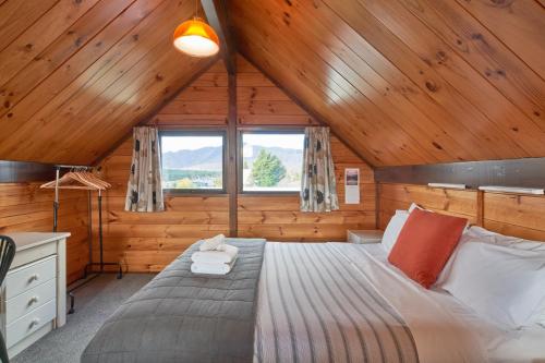 a bedroom with a bed in a wooden cabin at Retro Inn 1 - Lake Tekapo in Lake Tekapo