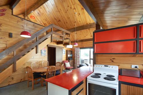a kitchen with a stove and a dining room with a table at Retro Inn 2 - Lake Tekapo in Lake Tekapo