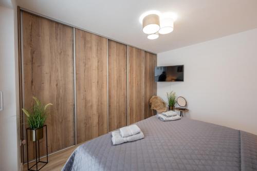 a bedroom with a bed with two towels on it at Apartmány Kaskády Luhačovice in Luhačovice