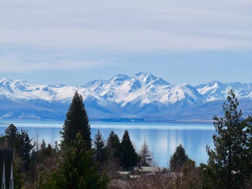 a view of a lake with snow covered mountains at Retro Inn 2 - Lake Tekapo in Lake Tekapo
