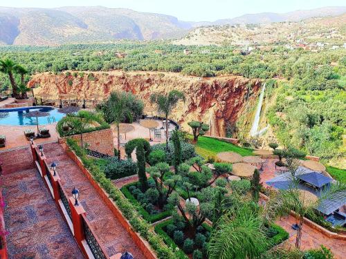 a view of a resort with a waterfall in the background at Borj Des Cascades & Spa in Ouzoud
