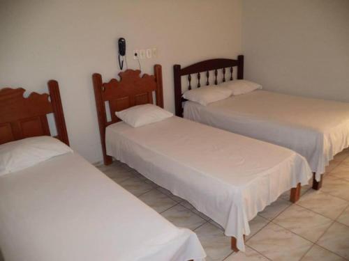 Postel nebo postele na pokoji v ubytování Hotel Comodoro