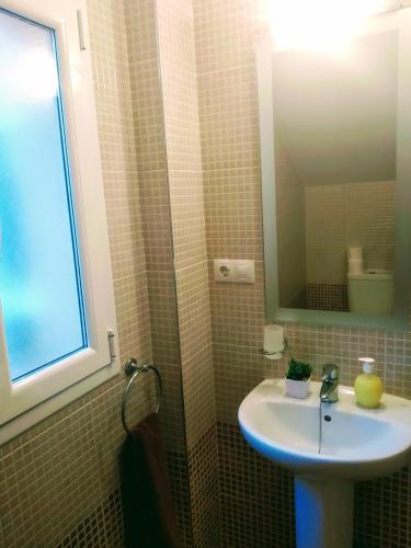 a bathroom with a sink and a mirror at Casa Rural Almécija in Illar