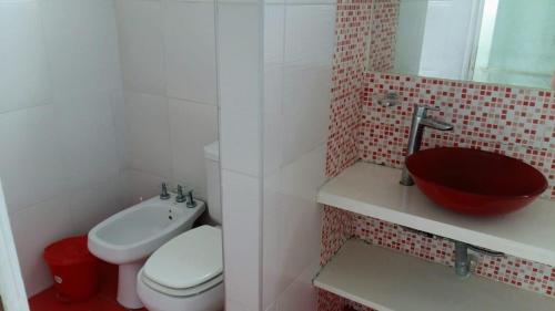 a bathroom with a toilet and a sink at Brisas 1 in Santa Teresita