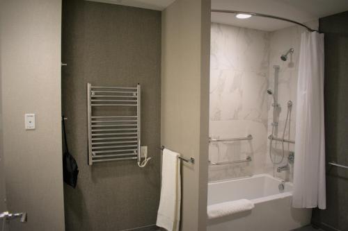 a bathroom with a bath tub and a shower at YO1 Longevity & Health Resorts, Catskills in Monticello