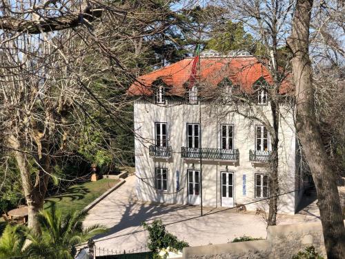 an old white house with a red roof at Luxurious royal estate in historic Sintra paradise in Sintra