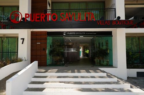 a building with a sign that reads puerto ayora was boutique at Hotel Puerto Sayulita in Sayulita