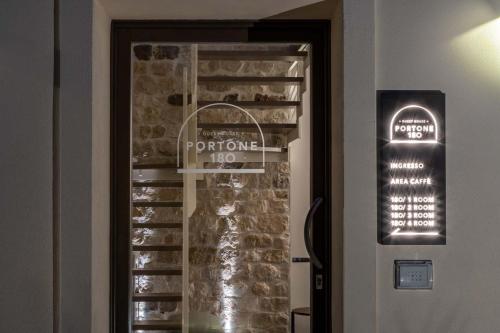 a door to a wine cellar with a sign on the wall at Portone180 Guest House in Roveredo in Piano