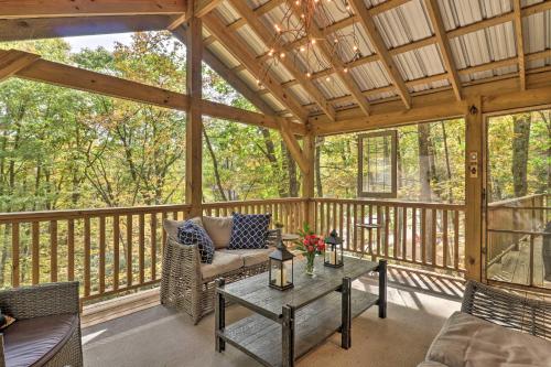 a screened in porch with a couch and a table at 1 Mi to Town Chalet-Style Highlands Retreat in Highlands