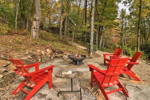 three red chairs and a fire pit in the woods at 1 Mi to Town Chalet-Style Highlands Retreat in Highlands