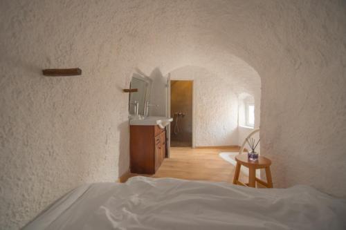 a bedroom with a bed and a sink in a room at Sophia Privilege in Oia