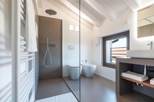 a bathroom with a shower and a sink and a toilet at Portone180 Guest House in Roveredo in Piano