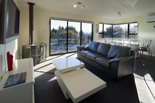 a living room with a couch and a table at Serendipity - Lake Tekapo in Lake Tekapo