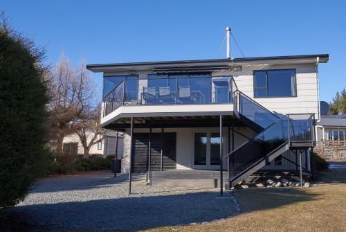 a house with a staircase in front of it at Serendipity - Lake Tekapo in Lake Tekapo
