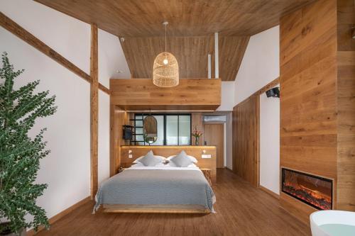 a bedroom with a bed and a fireplace at Rice View Lodge in Longsheng