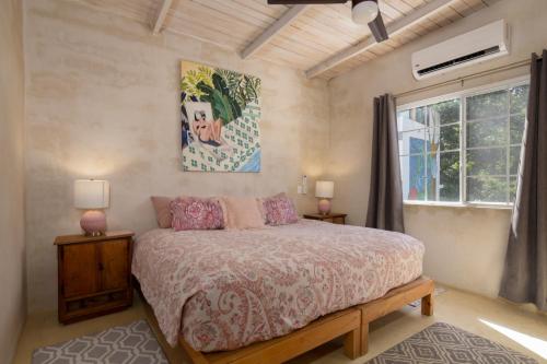 a bedroom with a large bed and a window at My Sisters House - Female only in Sayulita
