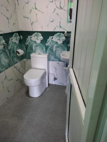 a bathroom with a toilet and a sink at Harry Guest House & Restaurant in Pokhara