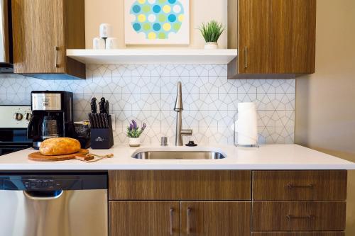 a kitchen with a sink and a counter top at Riverfront Park Travel Apartments in Spokane