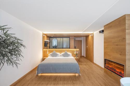 a hotel room with a bed and a fireplace at Rice View Lodge in Longsheng