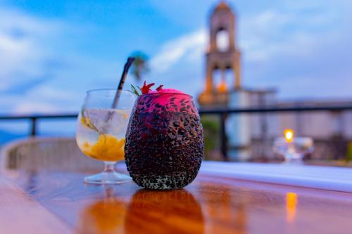 a strawberry sitting on a table next to a glass at Nukari Quinta Boutique in Jala