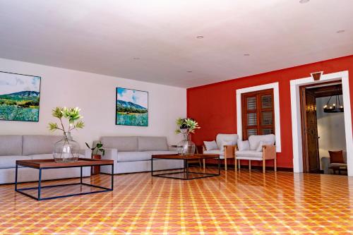 a living room with couches and tables and a red wall at Nukari Quinta Boutique in Jala