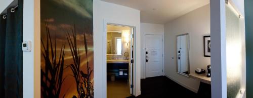 two pictures of a hallway with a bathroom at Hotel Indigo Waco by IHG in Waco