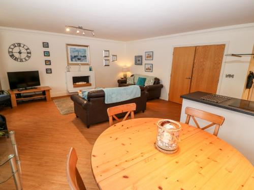 a living room with a table and a couch at Linksway in Morfa Nefyn
