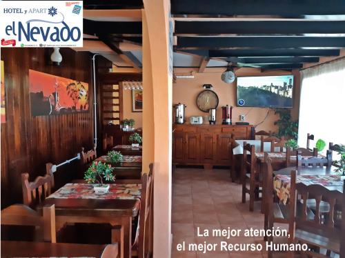 a restaurant with tables and chairs in a room at Hotel El Nevado, Malargüe Mendoza in Malargüe
