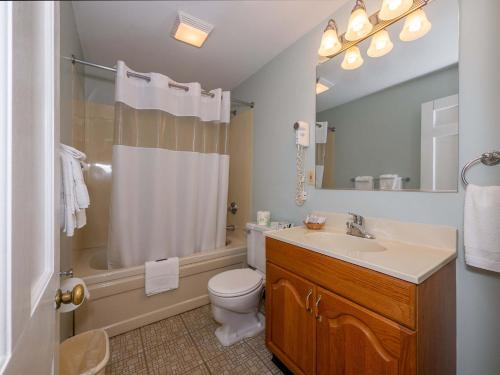 a bathroom with a sink and a toilet and a shower at Sea Latch Inn in York Beach