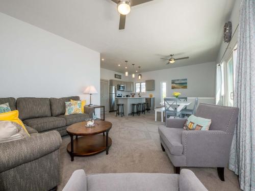 a living room with a couch and chairs and a table at Sea Latch Inn in York Beach