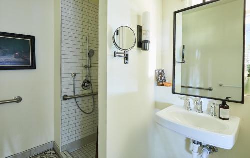 a white bathroom with a sink and a mirror at The Stavrand in Guerneville