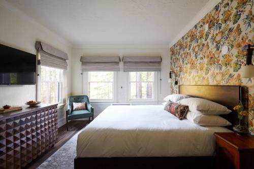 a bedroom with a large bed with a floral wallpaper at The Stavrand in Guerneville
