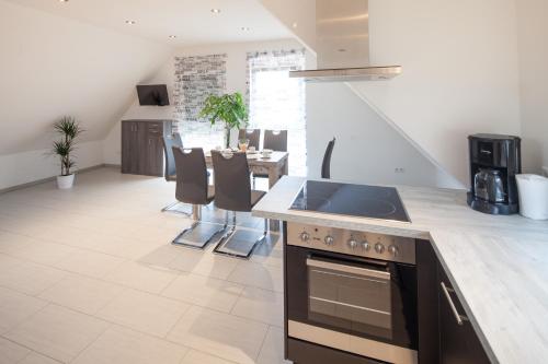 a kitchen with a sink and a stove top oven at Kiefer-Apartments in Rust