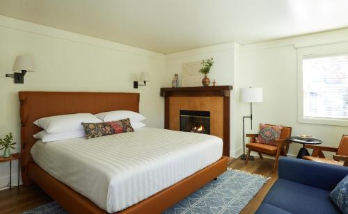 a bedroom with a bed and a fireplace at The Stavrand in Guerneville