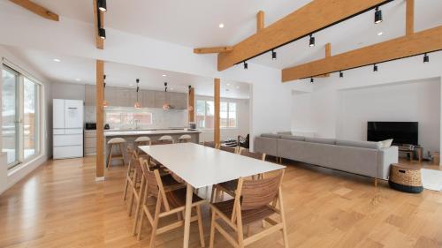 a kitchen and living room with a table and a couch at Country Resort Niseko in Kutchan