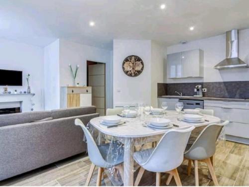 une cuisine et un salon avec une table et des chaises blanches dans l'établissement Morféo-le Vignemale, à Cauterets