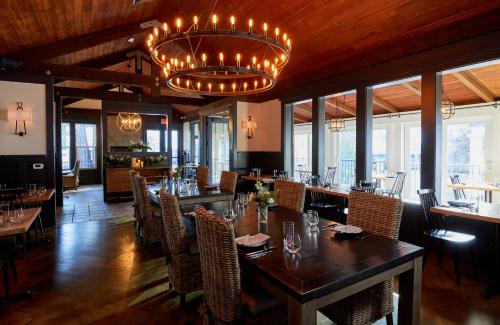 a restaurant with tables and chairs and a chandelier at The Stavrand in Guerneville