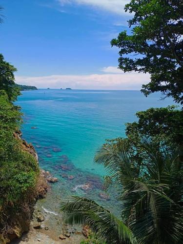 a view of the ocean from a hill with trees at Cliff View Bungalows in Ko Chang