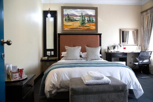 A bed or beds in a room at Constantia Manor Guest House