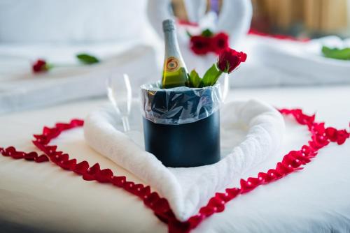 a heart shaped cake with a bottle of champagne and roses at River Inn at Seaside in Seaside