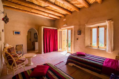 uma sala de estar com um sofá e uma mesa em La Maison Anglaise Garden Ecolodge em Tarudante