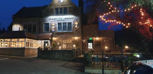 a building with christmas lights in front of it at The Strutt Arms in Belper