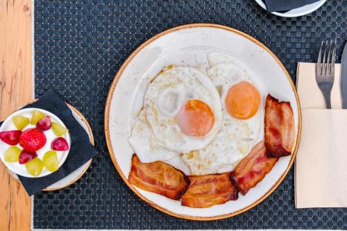 a plate of breakfast food with eggs and bacon at The Valentia Cabillers in Valencia
